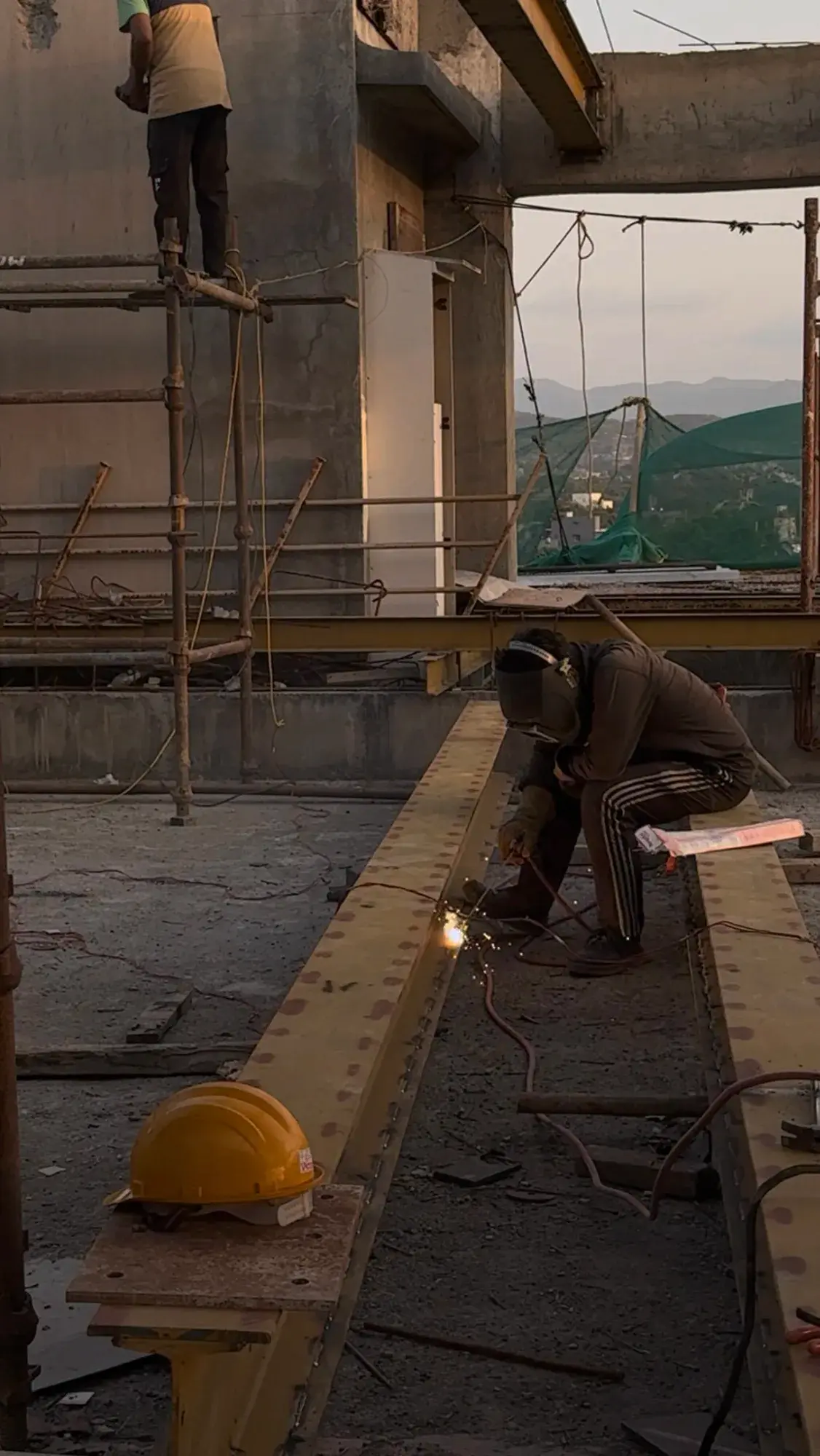 Welding a steel beam on site at Kalpvishwa
